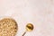 Delicious honey cheerios cereal in a bowl and golden spoon on pink background. Top view, copy space