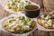 Delicious hot chalupas with chicken, cheese and green sauce close-up. horizontal