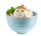 Delicious ice cream with caramel sauce, mint and nuts in bowl