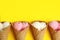 Delicious ice creams in wafer cones on yellow background, flat lay.