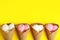 Delicious ice creams in wafer cones on yellow background. Space for text