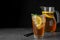 Delicious iced tea on grey table against black background  space for text