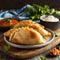 Delicious Indian samosa pastry presented on a plate with tomatoes and lettuce on a wooden table.