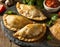 Delicious Indian samosa pastry presented on a plate with tomatoes and lettuce on a wooden table.