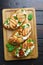 Delicious Italian antipasti bruschettas with grilled chicken, ri