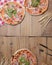 Delicious italian pizzas served on wooden table. Three pizza on rustic wooden background, copy space web design banner