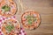 Delicious italian pizzas served on wooden table. Three pizza on rustic wooden background, copy space web design banner