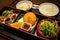 Delicious Japanese Lunch set contains fried chicken, salad, fruit, tofu and rice