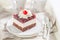 Delicious jelly cherry cake on white plate with cream
