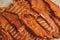Delicious jerky on a wooden background. products in craft packaging. snack for alcohol. macro photo. close-up