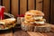 Delicious juicy hamburger and beef sandwich, wooden brown background, hot peppers, vegetables