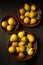 Delicious juicy homemade pears in plates on dark background in rustic style