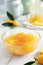 Delicious kumquat jam in glass bowl on white marble table