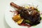 Delicious Lamb shank with red wine and rosemary gravy served on the mixed leaf salad