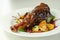 Delicious Lamb shank with red wine and rosemary gravy served on the mixed leaf salad