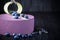 Delicious lavender cake with blueberries on wooden table