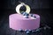Delicious lavender cake with blueberries on wooden table