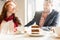 Delicious layered cake served with coffee on the table of a young couple