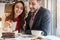 Delicious layered cake served with coffee on the table of a young couple