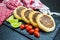 Delicious Lebanese food, genuine sfihas on a slate plate with tomatoes and lemons in the background with traditional Lebanese