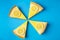 Delicious lemon pie slices on a blue background. Homemade sweet food. Minimalist style