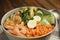 Delicious lentil bowl with avocado, shrimps, egg and cucumber on table, closeup