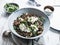 Delicious lentils bowl with zucchini, rucola, and cream fraiche