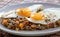 Delicious lentils with vegetable and fried egg