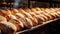 Delicious loaves of bread in a baker shop. Different types of bread loaves on bakery shelves