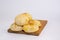 Delicious loaves of traditional Paraguayan chipa bread on a wooden tray in a bright kitchen