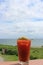 Delicious looking Bloody Mary drink on railing of seaside eatery