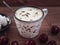 Delicious lunch with cherries, meringue cookies and coffee with cream in a ceramic mug with a teaspoon on a wooden board tray