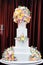 Delicious luxury white wedding cake decorated with cream flowers