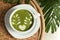 Delicious matcha latte in cup on coffee table, top view