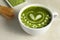 Delicious matcha latte in cup on marble table, closeup