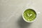 Delicious matcha latte in cup on marble table, top view. Space for text