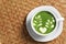 Delicious matcha latte in cup on wicker table, top view. Space for text