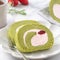 Delicious Matcha Swiss Roll Cake slices with strawberry cream on white background