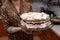 Delicious meringue cake held by housewives on a glass plate. Tasty pastries prepared at home