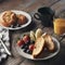 Delicious morning breakfast plate of french toasts with fresh berries and glass of juice on a wooden table