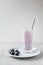 Delicious morning refreshing drink made of milk and blueberries in a glass of unusual shape with a beautiful texture and a