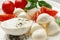 Delicious mozzarella with tomatoes and basil leaves on white plate, closeup