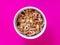 Delicious muesli isolated on a pink background