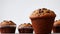 Delicious muffins with chocolate on table white background