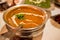Delicious Mulligatawny soup in metal bowl, traditional Indian cuisine