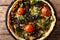 Delicious mushroom tart with cheese, greens and tomatoes close-up. Horizontal top view