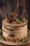 Delicious naked chocolate and hazelnuts cake on table rustic wood kitchen countertop