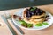 Delicious oats American pancakes with homemade chocolate toping, cooked blueberries and fresh mint leafs. Healthy lifestyle