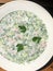 Delicious okroshka with kefir in a white plate