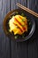 Delicious omurice omelette stuffed with rice, chicken and vegetables served on a plate. Vertical top view